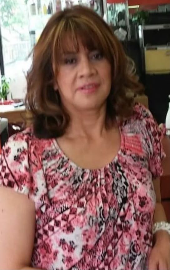 Grateful long-time client holding flowers at Martha's Unisex Beauty Studio LLC